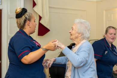 A staff member dancing with a resident