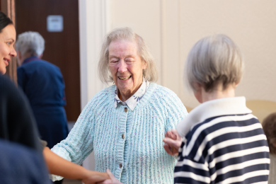 A resident laughing during a social gathering